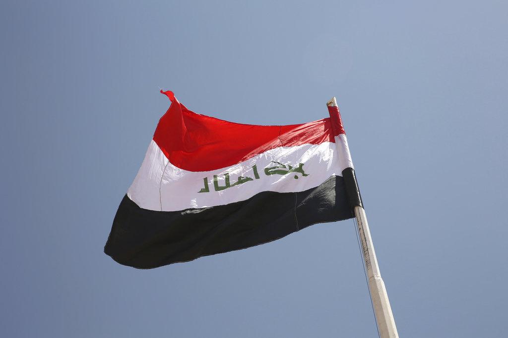 An Iraqi flag waves in the wind above the Iraqi Trebil border crossing on the Iraq-Jordan border on August 30, 2017. Iraq closed the crossing in 2015 after large areas, including the Anbar border province, fell to the Islamic State extremist group. The militants have since been pushed back in U.S.-backed offensives. (AP Photo/Sam McNeil)