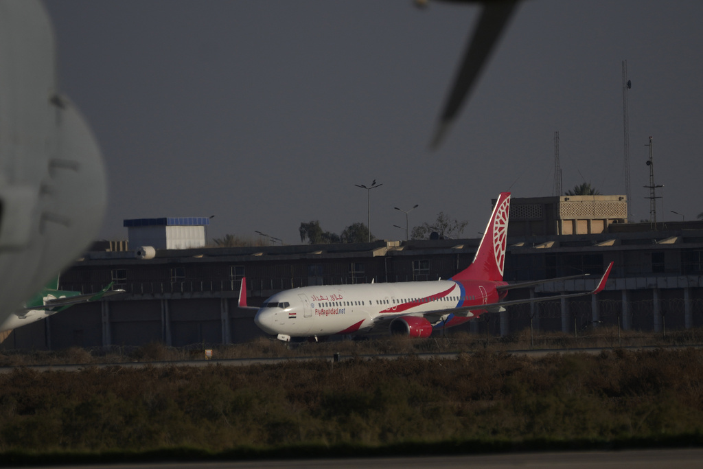 Planes belonging to the Iraqi airline Fly Baghdad are parked at Baghdad International Airport in Baghdad, Iraq, Wednesday, Jan. 24, 2024. The United States has slapped the airline and its CEO with sanctions, alleging assistance to Iran's military wing. (AP Photo/Hadi Mizban)