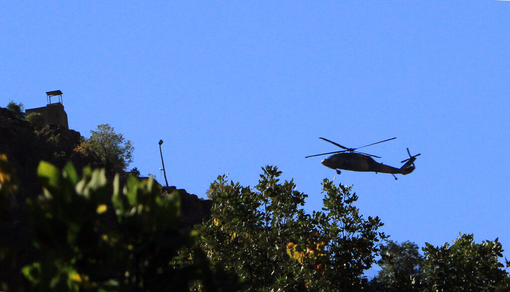 A Turkish military helicopter flies toward Iraq near Cukurca, Hakkari, Turkey, at the border with Iraq, Thursday, Oct. 20, 2011. .(AP Photo)