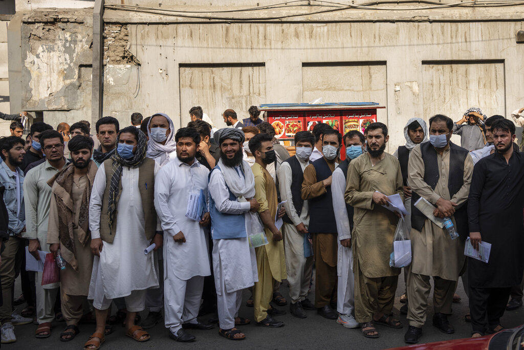 Afghans line up outside the Iranian Embassy to request travel visas in Kabul, Afghanistan, Wednesday, Sept. 29, 2021. (AP Photo/Bernat Armangue)
