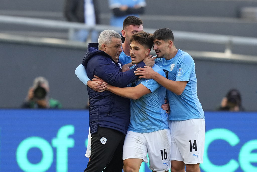 Israel's Ran Binyamin (16) is congratulated after scoring his side's opening goal against South Korea during the FIFA U-20 World Cup the third-place soccer match at the Diego Maradona stadium in La Plata, Argentina, Sunday, June 11, 2023. (AP Photo/Natacha Pisarenko)
