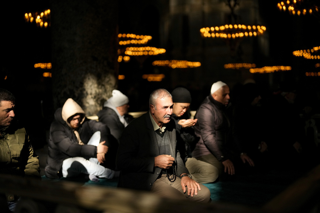 Muslim worshippers pray at Byzantine-era Hagia Sophia mosque in Istanbul, Turkey, Friday, Jan. 12, 2024. (AP Photo/Francisco Seco)