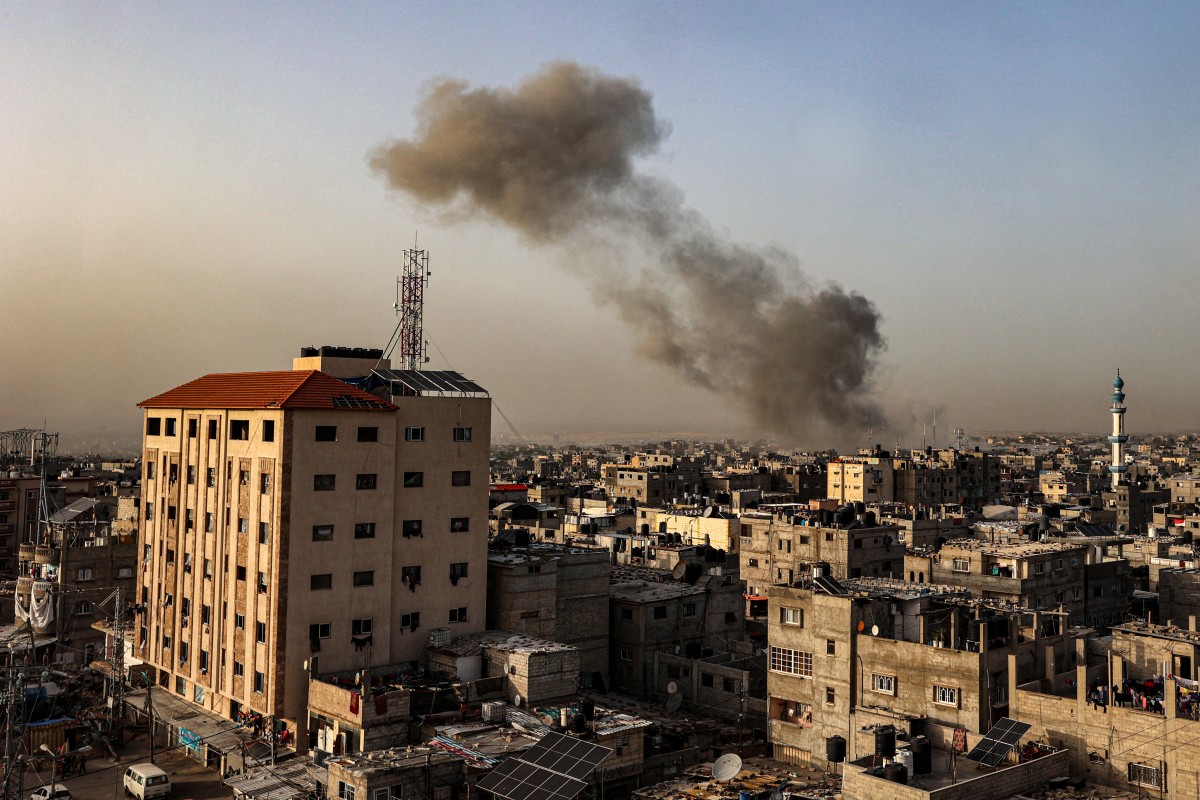 Smoke billows over buildings following Israeli bombardment in Rafah in the southern Gaza Strip on March 27, 2024. (Photo by SAID KHATIB/AFP)