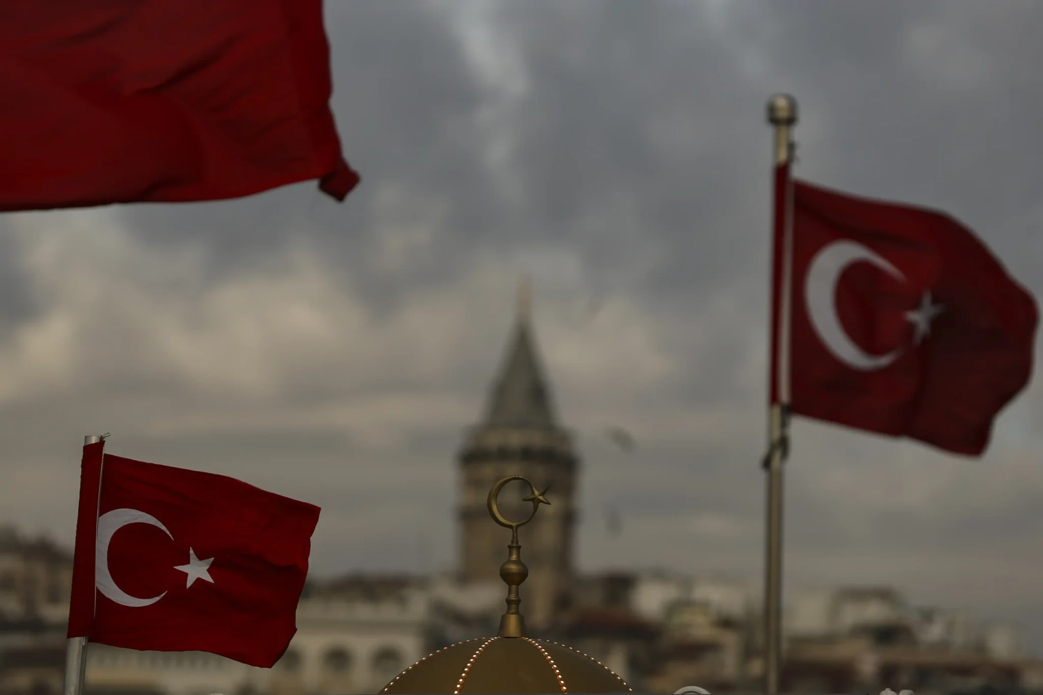Turkish flag flies over the roof of a building in Istanbul. Photo: AP