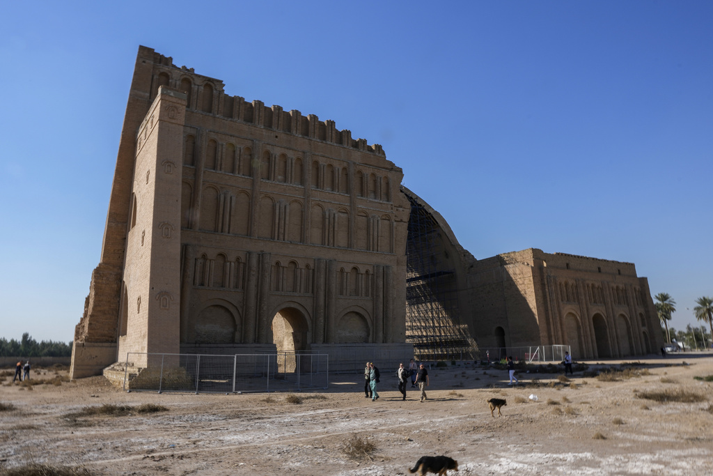 Western tourists visit the Great Arch of Ctesiphon a 3rd to 6th-century Persian ruin on the Tigris River Anear the modern town of Salman Pak, south of Baghdad, Friday, March 1, 2024. (AP Photo/Hadi Mizban)