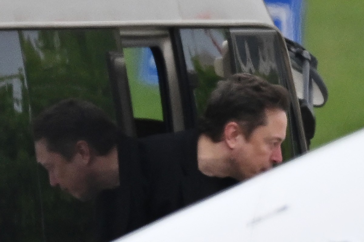 Tesla CEO Elon Musk gets off a minibus before boarding his private plane at Beijing airport on April 29, 2024. Photo: AFP 