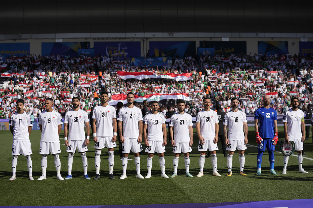 Iraq National team players stand for their national anthem prior to the Asian Cup Group D soccer match between Iraq and Vietnam at Jassim Bin Hamad Stadium in Doha, Qatar, Wednesday, Jan. 24, 2024. (AP Photo/Aijaz Rahi) 