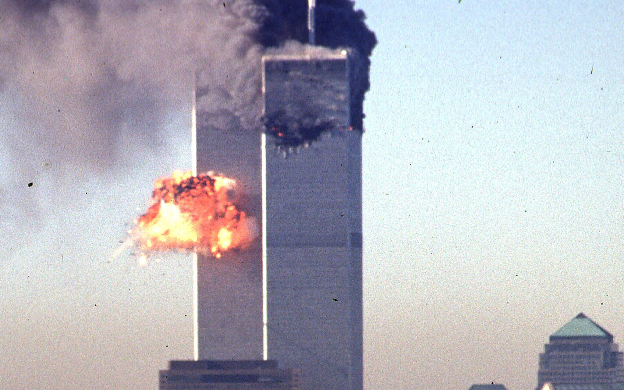 (FILE) In this file photo smoke and flames erupt from the twin towers of the World Trade Center after commercial aircraft were deliberately crashed into the buildings in lower Manhattan, New York on September 11, 2001. (Photo by SETH MCALLISTER / AFP)
