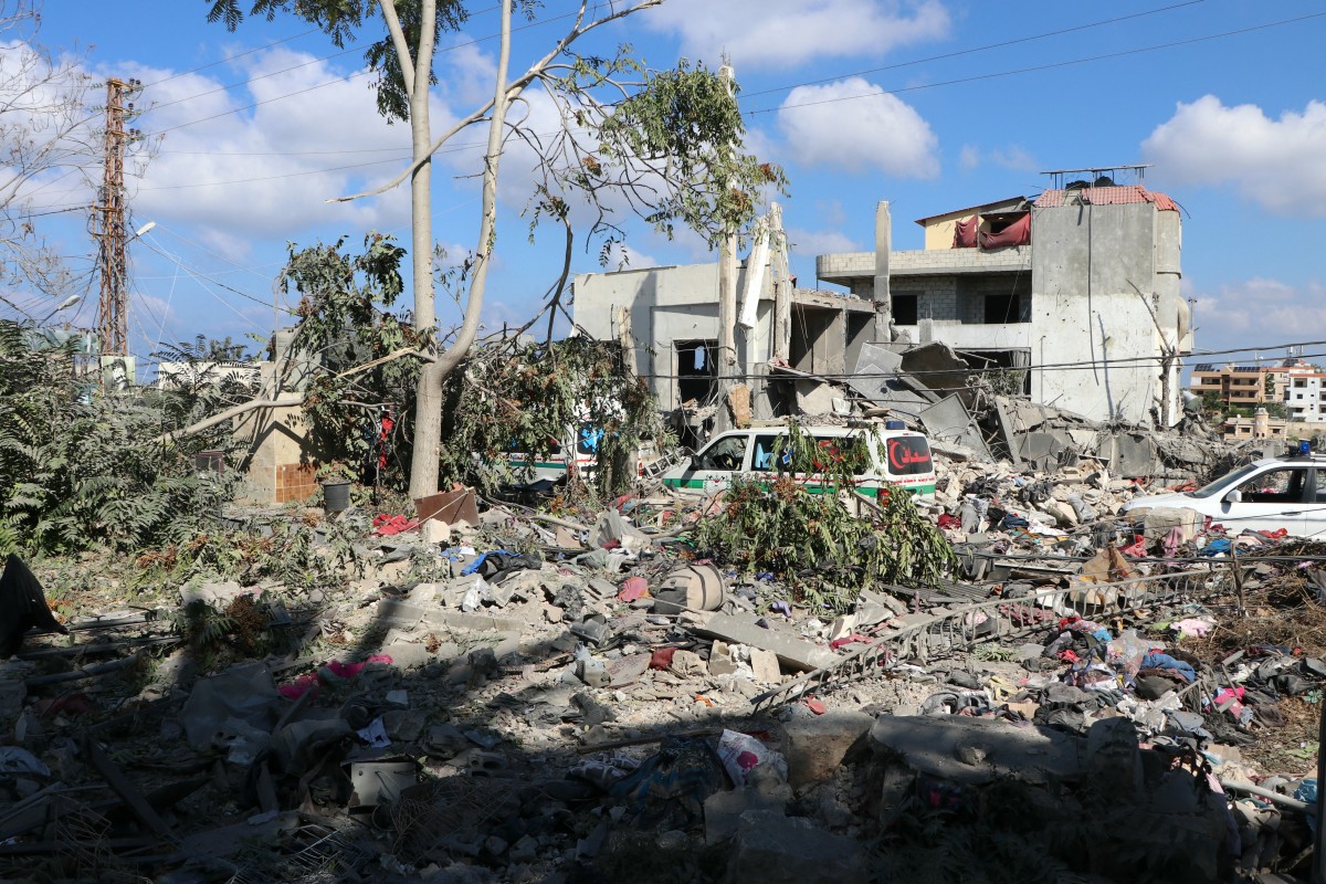 Ambulances carrying the bodies of civil defence workers affiliated with the Islamic al-Rissala scouts association killed in an Israeli strike, drive amid the destruction in the southern Lebanese town of Tayr Dibba, on September 29, 2024. - Israel said on September 29 that it was carrying out new air raids against "dozens" of Hezbollah targets in Lebanon, after killing the Iran-backed group's leader, Hassan Nasrallah. (Photo by AFP)