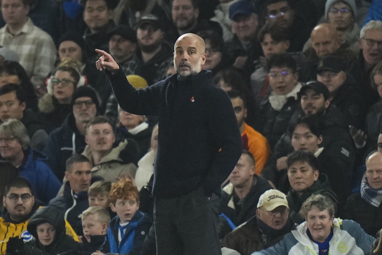 Manchester City's head coach Pep Guardiola reacts during the English Premier League soccer match between Brighton and Manchester City at Falmer Stadium in Brighton, England. (AP Photo/Alastair Grant)