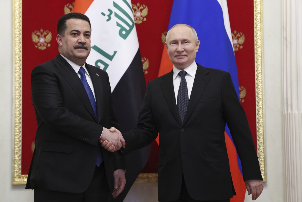 FILE PHOTO : Russian President Vladimir Putin, right, and Iraq's Prime Minister Mohammed Shia' Al Sudani pose for a photo during their meeting at the Kremlin in Moscow, Russia, Tuesday, Oct. 10, 2023. (Sergei Bobylev, Sputnik, Kremlin Pool Photo via AP)