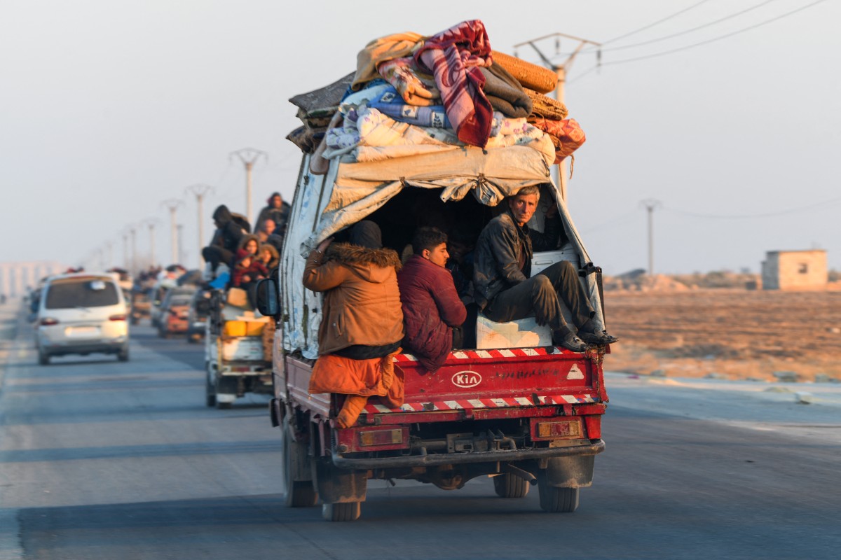Displaced Syrian Kurds drive vehicles loaded with belongings on the Aleppo-Raqqa highway to flee areas on the outskirts of the northern city of Aleppo which were formerly controlled by the Kurdish-led Syrian Democratic Forces (SDF), after they were seized by Islamist-led rebels on December 2, 2024.