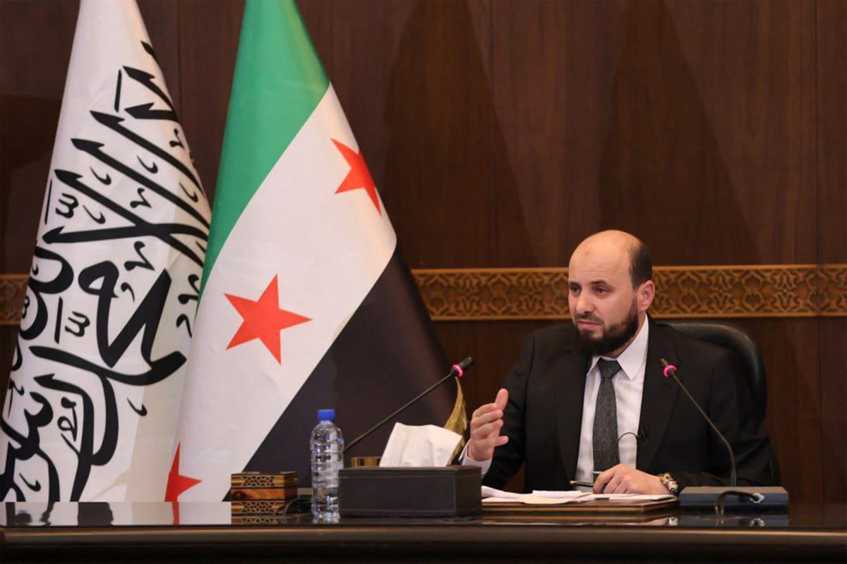 This handout image made available by the Telegram channel of the official Syrian Arab News Agency (SANA) shows Syria's new transitional prime minister Mohammad al-Bashir chairing a meeting of the new cabinet in Damascus on December 10, 2024.