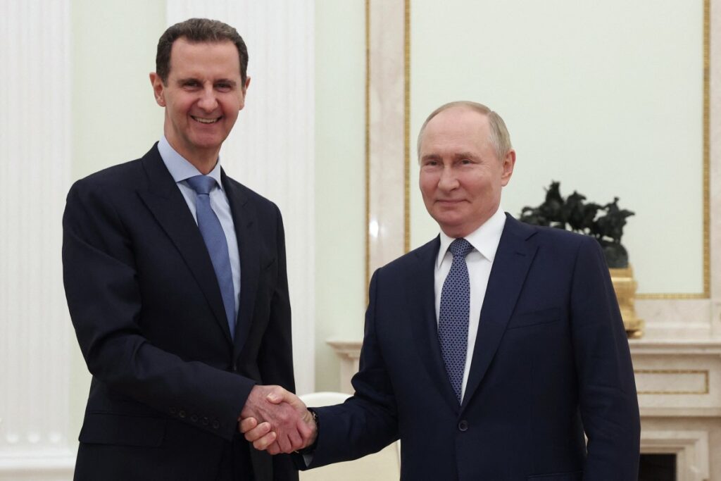 In this pool photograph distributed by the Russian state agency Sputnik on July 25, 2024, Russia's President Vladimir Putin (R) shakes hands with Syria's President Bashar al-Assad during their meeting at the Kremlin in Moscow on July 24, 2024. (Photo by Valery SHARIFULIN / POOL / AFP) / EDITOR'S NOTE : THIS IMAGE IS DISTRIBUTED BY RUSSIAN STATE OWNED AGENCY SPUTNIK