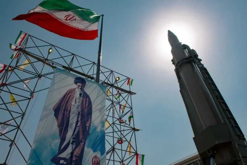 A banner depicting Iran’s Supreme Leader Ayatollah Ali Khamenei is placed next to a ballistic missile in Baharestan Square in Tehran on Sept. 26, 2024. Hossein Beris / Middle East Images / Middle East Images via AFP