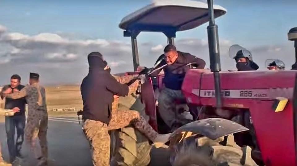 This is a photo of a farmer being assaulted by Iraqi army soldiers in Kirkuk.