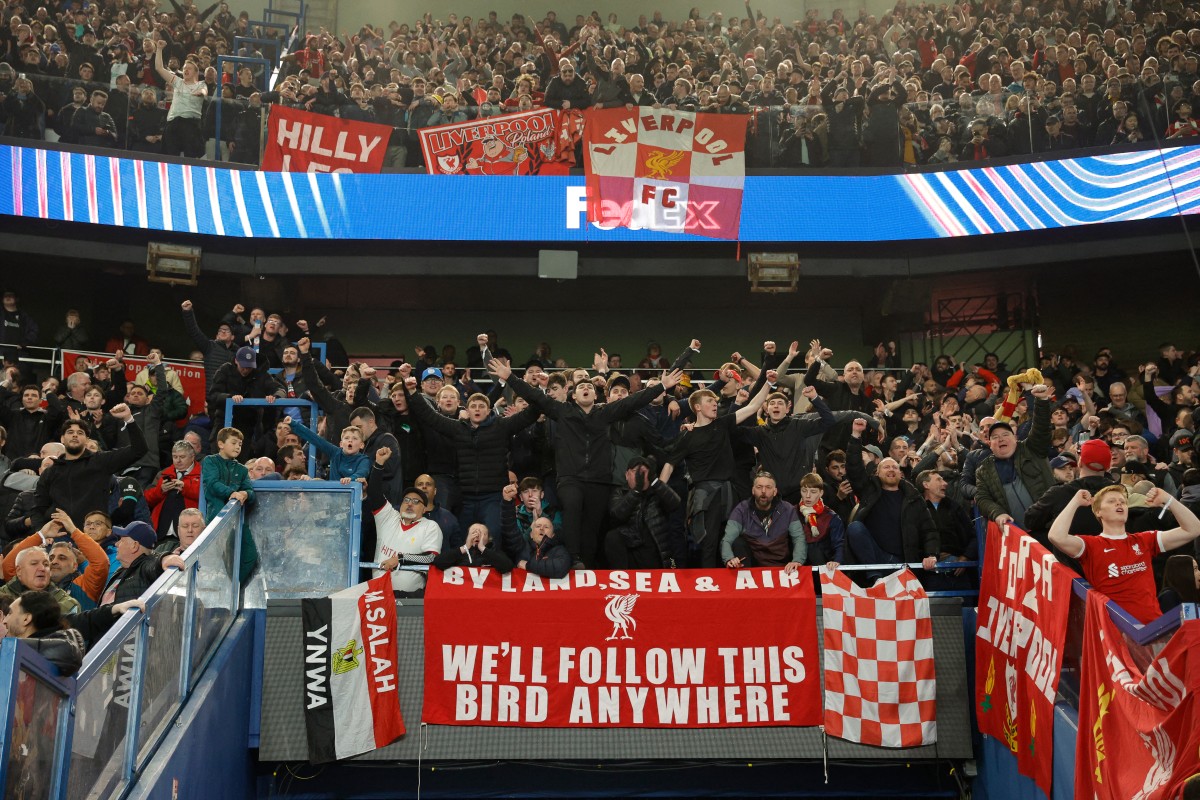 Liverpool supporters celebrate their team's victory at the end of the UEFA Champions League Round of 16 first leg football match between Paris Saint-Germain (FRA) and Liverpool (ENG) at the Parc des Princes stadium in Paris on March 5, 2025. (Photo by GEOFFROY VAN DER HASSELT / AFP)