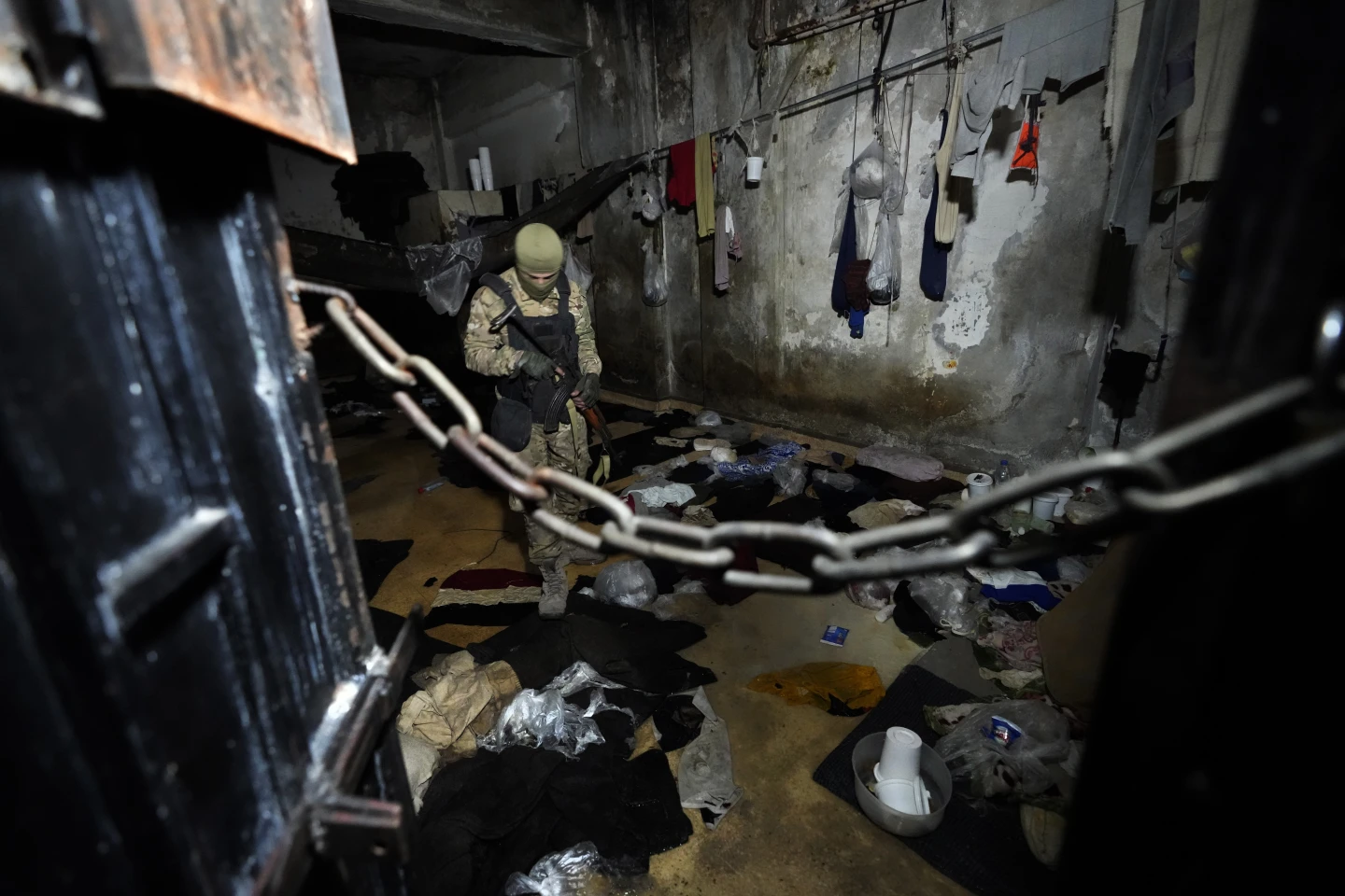 A member of the security forces of the new interim Syrian government inspects a cell in Damascus, Syria. Photo: AP / Hussein Malla