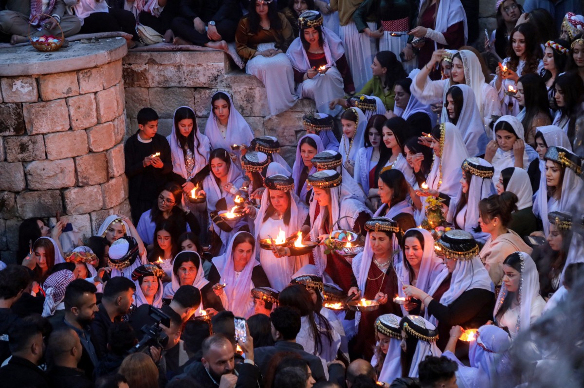 Iraqi Yazidis light candles outside Lalish Temple in Iraq's northern Kurdish region to mark the Yazidi New Year on April 15, 2025. AFP / Safin Hamid