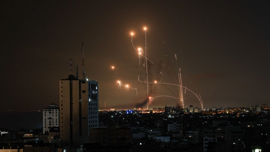 An Israeli missile launched from the Iron Dome defence missile system attempts to intercept a rocket, fired from the Gaza Strip, over the city of Netivot in southern Israel on October 8, 2023. (Photo by MAHMUD HAMS / AFP)