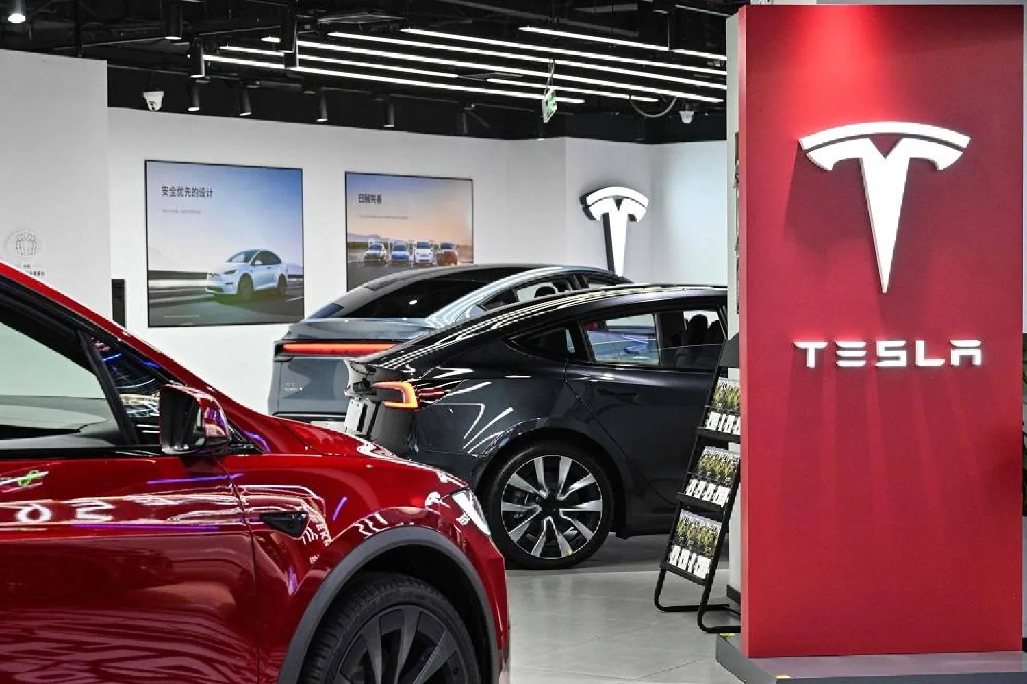 Tesla cars are seen at a showroom for the US electric vehicle maker at a mall in the Changning district of Shanghai on February 25, 2025. (AFP)
