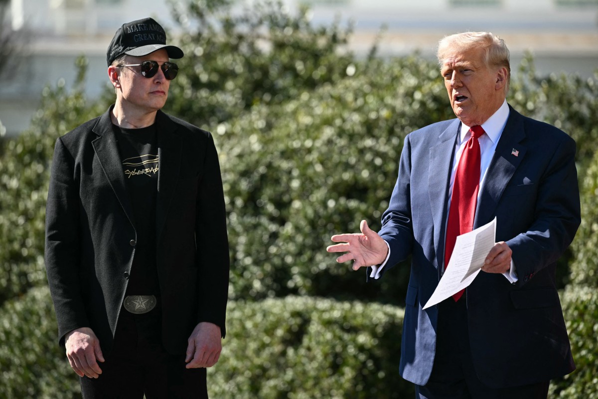 US President Donald Trump and Tesla CEO Elon Musk speak to the press as they stand next to a Tesla vehicle on the South Portico of the White House on March 11, 2025 in Washington, DC.