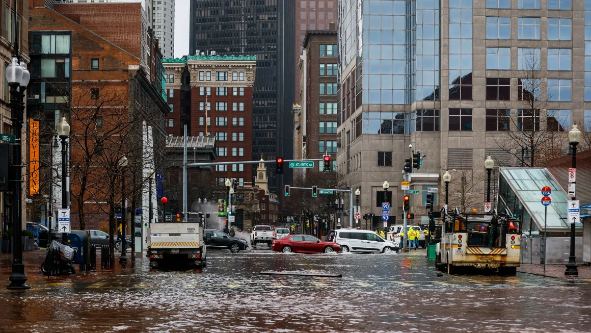 Cars travel through floodwaters in Boston at high tide during a winter storm and strong onshore winds on January 13. Erin Clark/The Boston Globe/Getty Images