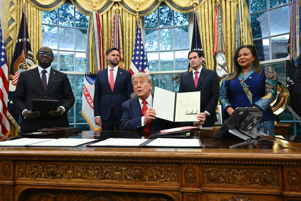 US President Donald Trump holds a letter addressed to Congolese President Felix Tshisekedi congratulating him on the peace agreement with Rwanda during a meeting with Democratic Republic of the Congo Foreign Minister Thérèse Kayikwamba Wagner (R) and Rwandan Foreign Minister Olivier Nduhungirehe (L) in the Oval Office of the White House in Washington, DC, on June 27, 2025. Also in the meeting, L-R, US Vice President JD Vance and US Secretary of State Marco Rubio. Rwanda and the Democratic Republic of Congo signed an agreement in Washington on Friday to put an end to a conflict in the eastern DRC that has killed thousands, although broad questions loom on what it will mean. Trump has trumpeted the diplomacy that led to the deal and publicly complained that he has not received a Nobel Peace Prize. (Photo by ANDREW CABALLERO-REYNOLDS / AFP)