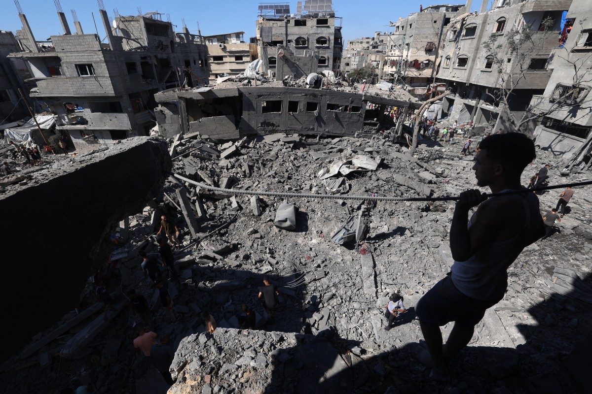 A Palestinian inspects damage after an Israeli strike in Al-Bureij camp, Gaza, July 4, 2025. Photo: Eyad Baba / AFP