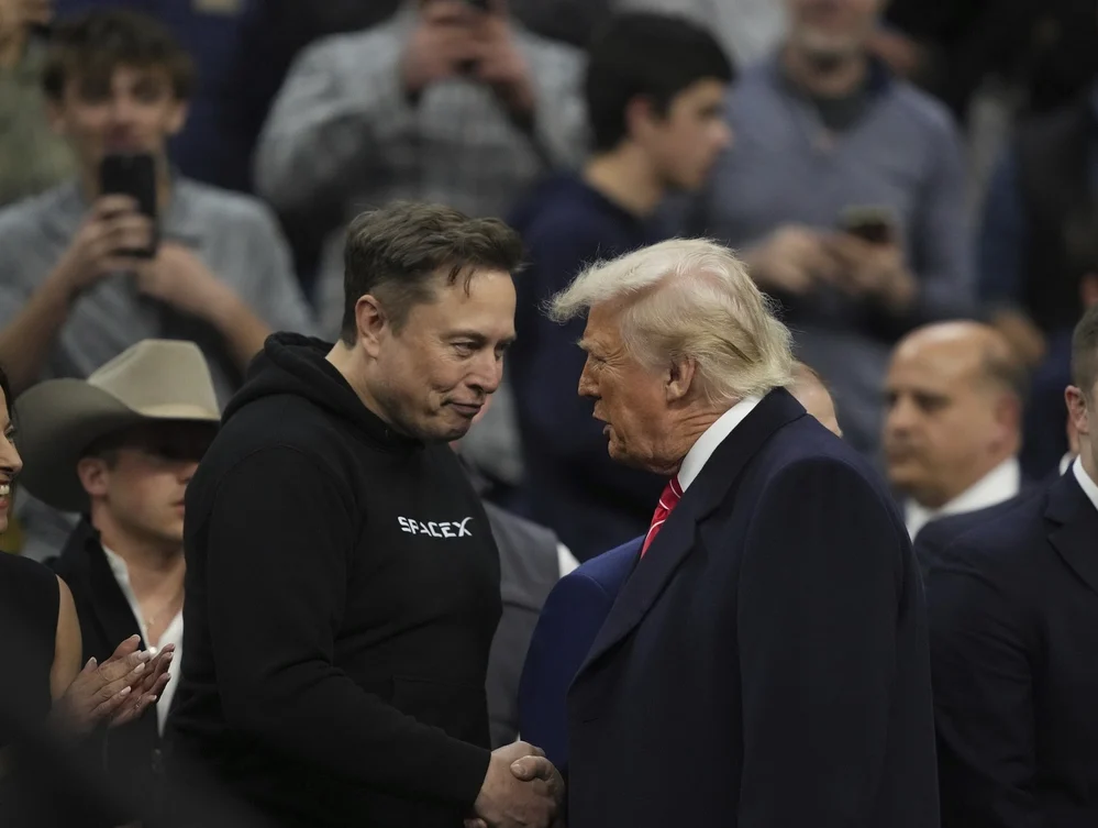 Elon Musk (left) shakes hands with President Donald Trump at the finals for the NCAA wrestling championship in Philadelphia on March 22, 2025. Photo: Matt Rourke / AP