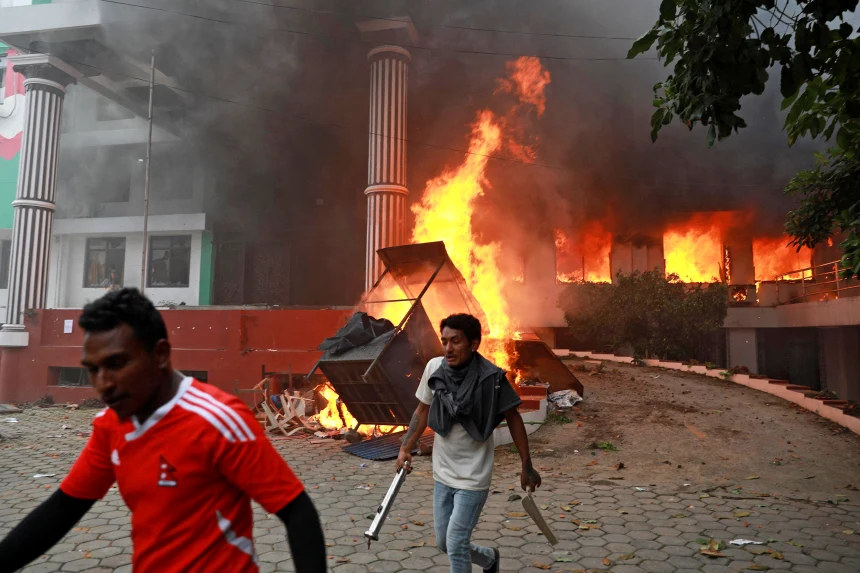 Demonstrators outside the burning Nepali Congress Party office during a protest to condemn the police's deadly crackdown on demonstrators, in Kathmandu on Tuesday. Prabin Ranabhat / AFP 