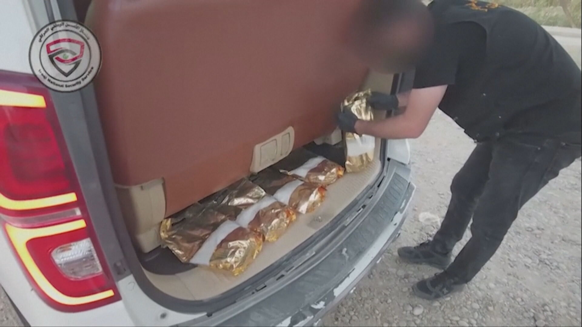 Iraqi Counter-Narcotics officers inspect seized packages of narcotics following a joint operation with Syrian authorities. Photo: The Iraqi National Security Service / Handout  