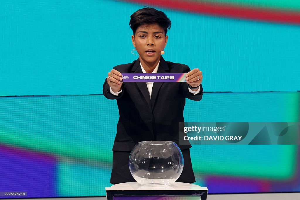 Indian footballer Sangita Basfore holds up Iran during the 2026 AFC Women's Asian Cup football draw in Sydney on July 29, 2025. 