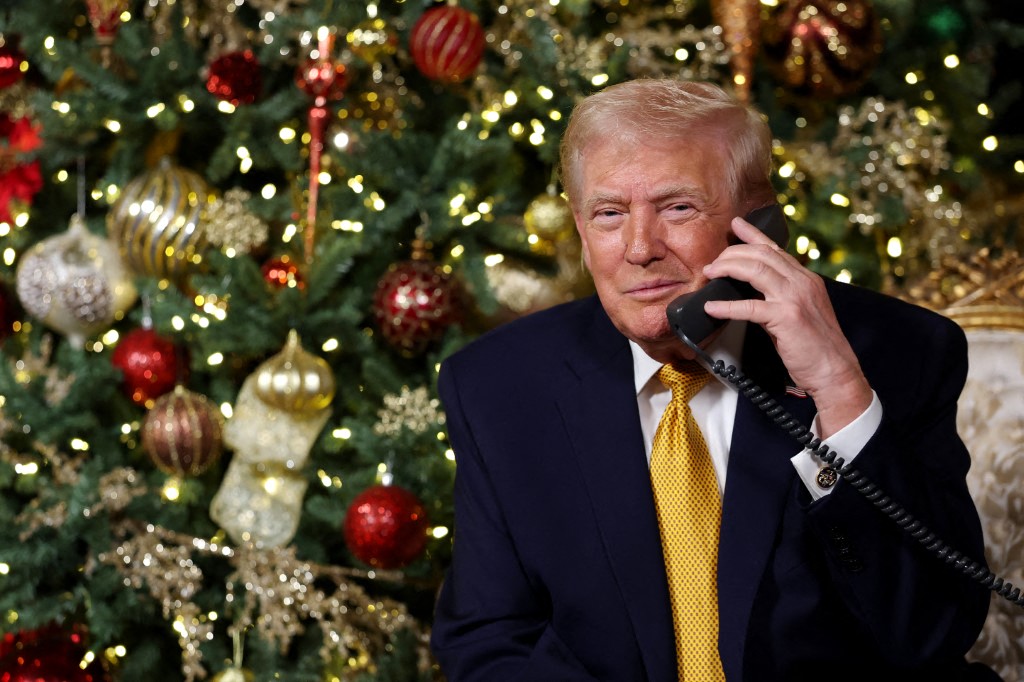 U.S. President Donald Trump calls children while tracking Santa with NORAD on Christmas Eve at Mar-a-Lago in Palm Beach, Florida, December 24, 2025. (AFP)