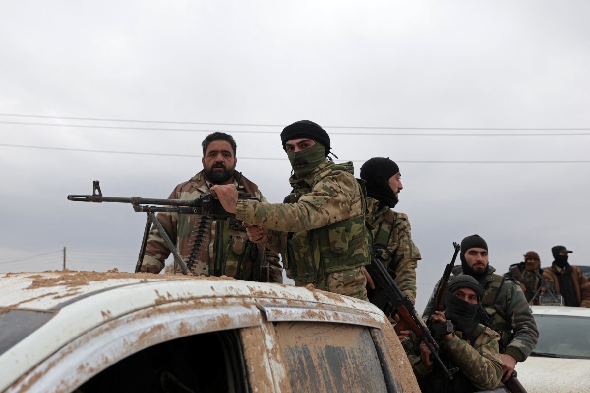 Syrian army soldiers in their vehicles enter the Deir Hafer town on January 17, 2026. 