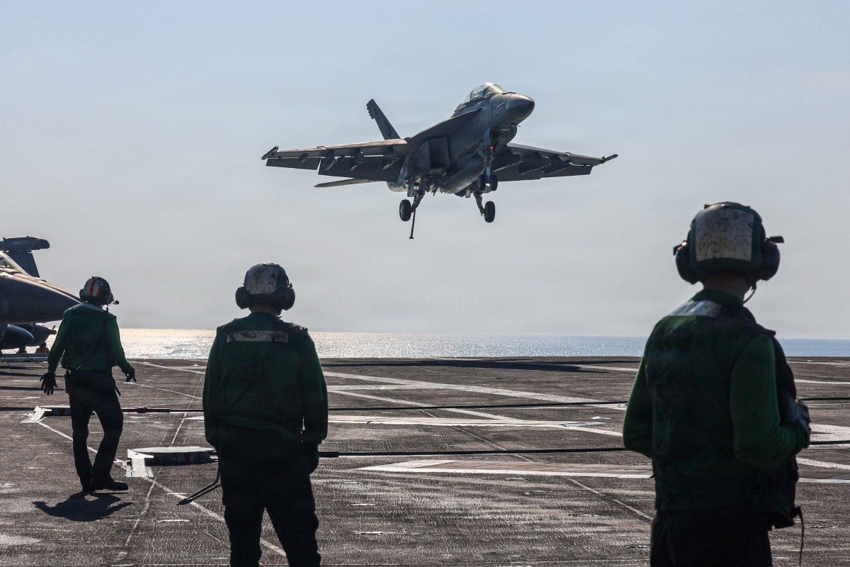 In this handout photograph released by the US Navy on February 6, 2026, an F/A-18F Super Hornet, attached to Strike Fighter Squadron (VFA) 41, makes an arrested landing on the flight deck of Nimitz-class aircraft carrier USS Abraham Lincoln in the Arabian Sea on January 30, 2026.
 