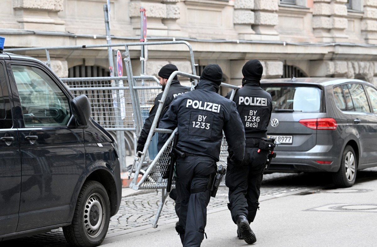 Policemen carry barrier fences close to the Hotel Bayerischer Hof, venue of the Munich Security Conference (MSC) in Munich, southern Germany on February 13, 2026.
 