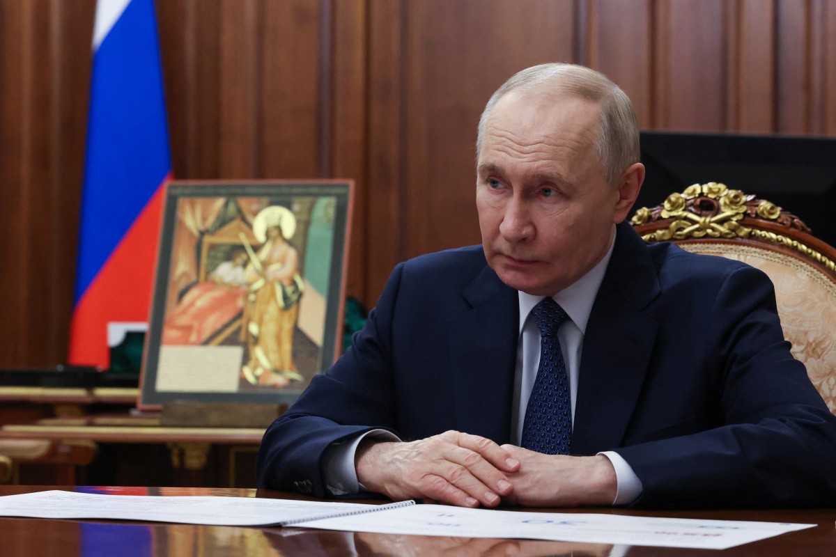 In this pool photograph distributed by the Russian state agency Sputnik, Russia's President Vladimir Putin attends a meeting with Archpriest Alexander Tkachenko (not pictured), Chairman of the Board at the Circle of Kindness Foundation, in Moscow on February 13, 2026. (Photo by Vyacheslav PROKOFYEV / POOL / AFP)