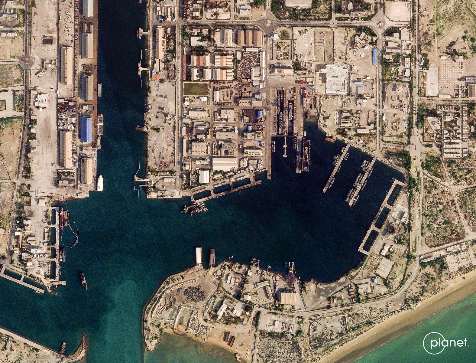 This handout satellite image taken by 2026 Planet Labs PBC shows damage at the military harbour in Iran's southern port of Bandar Abbas along the Strait of Hormuz on March 4, 2026. (Photo by 2026 Planet Labs PBC / AFP) 