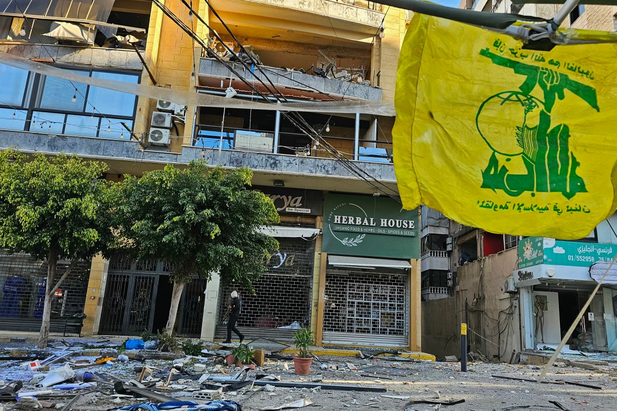 A flag of Hezbollah flutters at the site of destroyed buildings following airstrikes in Beiruts southern suburbs of Ghobeiry neighborhood, on March 5, 2026. Israel said it carried out strikes on Beirut targeting Iran-backed militant group Hezbollah on March 5, while Lebanese state media reported an Israeli drone strike killed a Hamas official. (Photo by AFP)