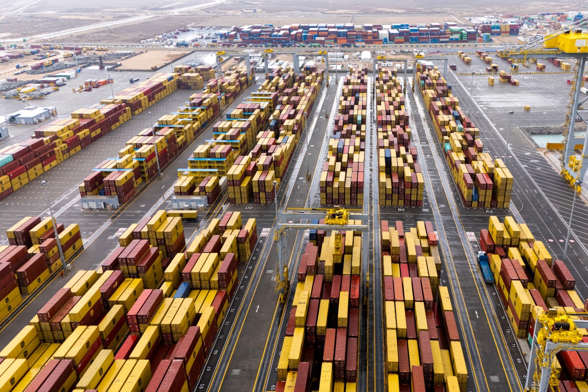 This aerial photo shows stacked shipping containers at Umm Qasr Port in Basra on March 12, 2026. Oil-rich Iraq has long been a proxy battleground between the United States and Iran, and saw itself dragged straight into the Middle East war after Israel and the US attacked Iran on February 28. (Photo by Hussein FALEH / AFP)