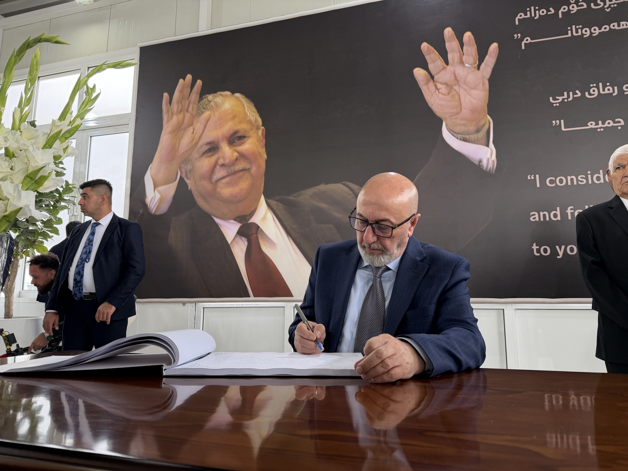 Iraqi President Nizar Amedi writes in the Memorial Book of the late President Jalal Talabani in Sulaymaniyah on 13 April 2026


