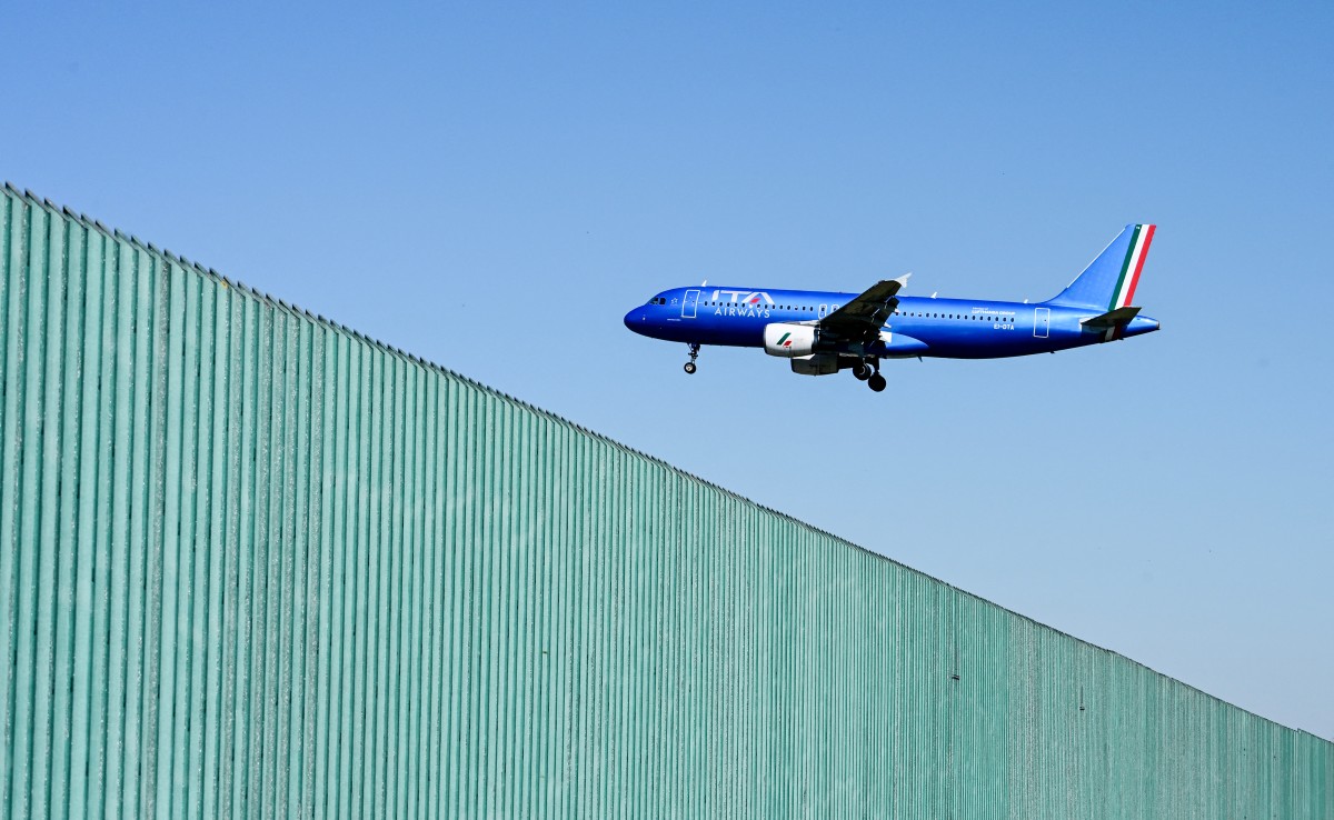 An Ita Airways airplane lands at Milan Linate airport northern Italy, on April 7, 2026. (Photo by Stefano RELLANDINI / AFP)