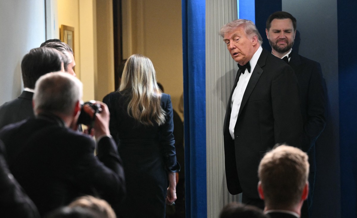 US President Donald Trump departs after a press briefing in the Brady Briefing Room at the White House in Washington, DC, shortly after a shooting incident at the White House Correspondents Dinner on April 25, 2026. US President Donald Trump said April 25 he would give a press conference from the White House press briefing room, shortly after a shooting incident at a gala dinner in Washington. The press conference is set to take place shortly after 10 p.m. (0200 GMT), Trump wrote on his Truth Social platform, adding: "The First Lady, plus the Vice President, and all Cabinet members, are in perfect condition." (Photo by Mandel NGAN / AFP)