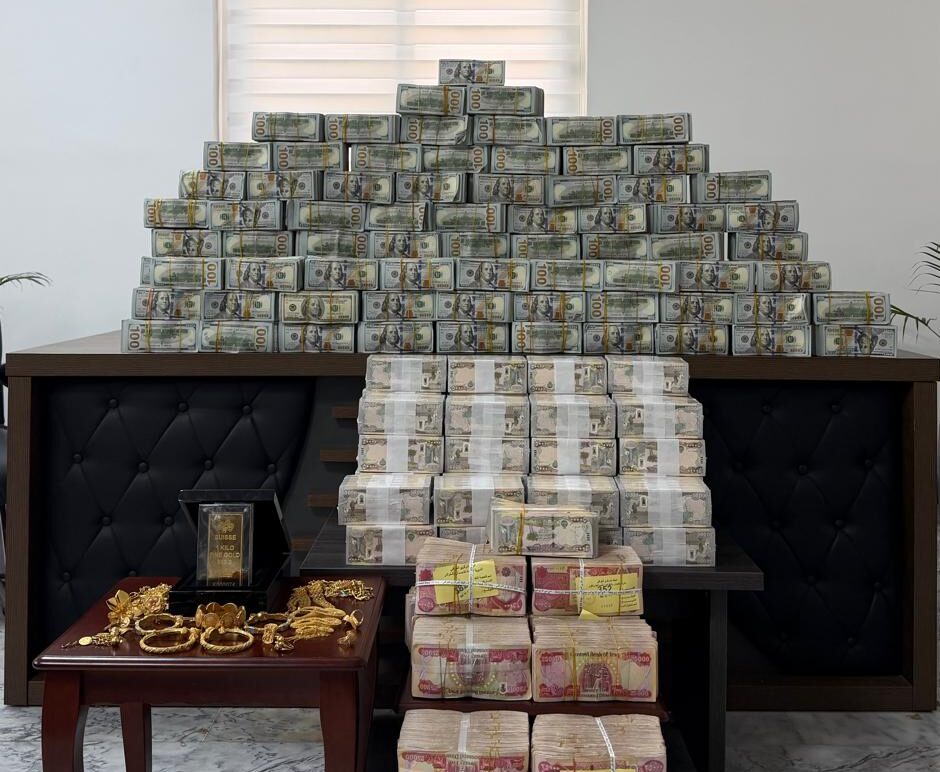 Millions of dollars in US currency, billions in Iraqi dinars, gold jewelry, and weapons confiscated by authorities following the arrest of former Deputy Minister of Oil Adnan al-Jumaili. Photo: Supreme Judicial Council 
