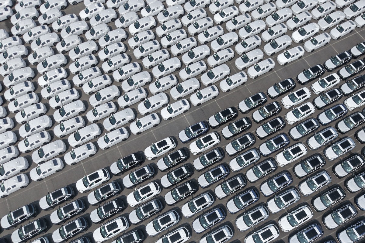 This photo shows an aerial view of new electric vehicles waiting to be loaded for export at Shanghai Port in Shanghai on May 9, 2026. (Photo by CN-STR / AFP) / China OUT