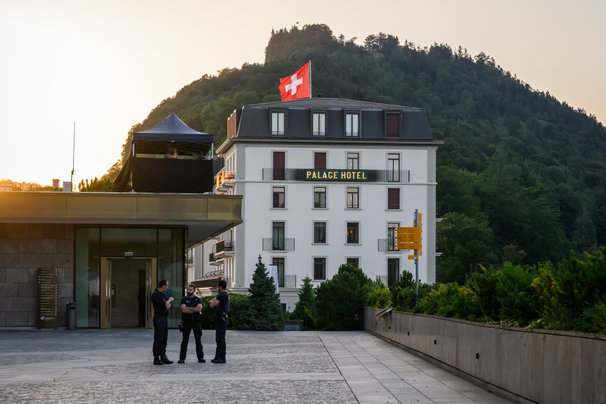 Police officers stand next to a building at the Burgenstock luxury hotel complex overlooking Lake Lucerne, Switzerland, on June 21, 2026. 