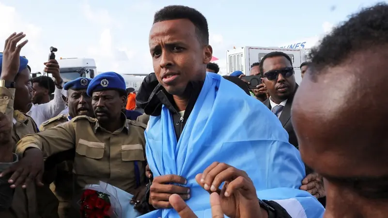 Somali referee Omar Abdulkadir Artan, who had been expected to officiate at matches during the 2026 FIFA World Cup but was denied entry to the United States, is received as he arrives at the Aden Abdulle Osman International Airport in Mogadishu, Somalia June 10, 2026.