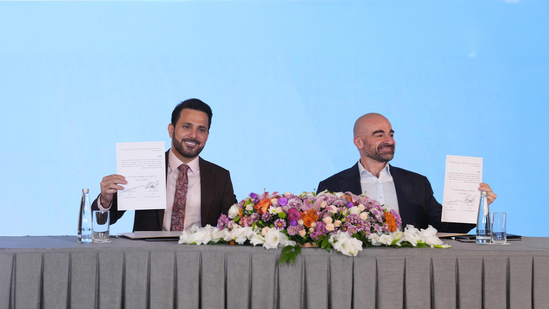 Bafel Jalal Talabani (right), President of the Patriotic Union of Kurdistan (PUK), and Shaswar Abdulwahid (left), President of the New Generation Movement, present copies of their newly signed strategic alliance agreement during a formal ceremony. July 2, 2026