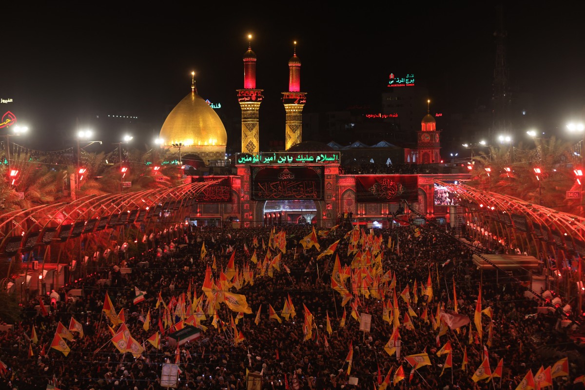 Mourners take part in the funeral procession of Iran's late supreme leader Ayatollah Ali Khamenei at Imam Hussein Shrine in Karbala early on July 9, 2026. Iranians were preparing on July 9 to bury their slain leader Ali Khamenei in his hometown of Mashhad in northeast Iran, as new US strikes threatened to trigger a fresh escalation in the Middle East war. The late leader's burial follows a multi-day funeral ceremony that attracted millions of mourners across various cities in both Iran and Iraq. (Photo by Ahmad AL-RUBAYE / AFP)